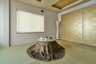 a room with a tree stump table in the middle at \u30b3\u30f3\u30c9\u30df\u30cb\u30a2\u30e0\u30db\u30c6\u30eb \u6e0b\u8c37GOTEN Condominium Hotel Shibuya GOTEN in Tokyo