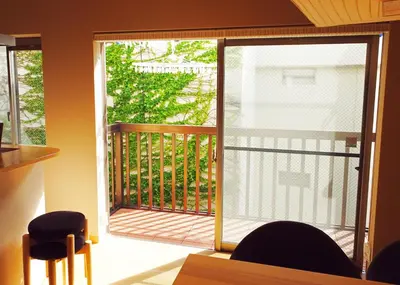 a sliding glass door to a balcony with a deck at \u30b3\u30f3\u30c9\u30df\u30cb\u30a2\u30e0\u30db\u30c6\u30eb \u6e0b\u8c37GOTEN Condominium Hotel Shibuya GOTEN in Tokyo