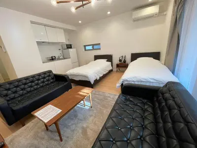 a living room with two beds and a couch at SALON Shibuya in Tokyo