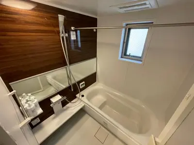 a white bathroom with a tub and a window at SALON Shibuya in Tokyo