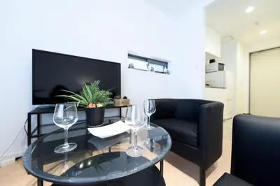 a living room with a table with wine glasses on it at SALON Shibuya in Tokyo