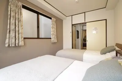 a bedroom with two beds and a window at 2-9-13 / Vacation STAY 4897 in Tokyo