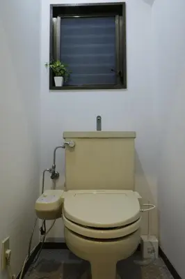 a bathroom with a toilet and a window with a plant at 2-9-13 / Vacation STAY 4897 in Tokyo