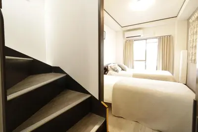 a hotel room with two beds and a mirror at 2-9-13 / Vacation STAY 4897 in Tokyo
