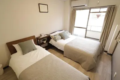 two beds in a room with a window at 2-9-13 / Vacation STAY 4897 in Tokyo