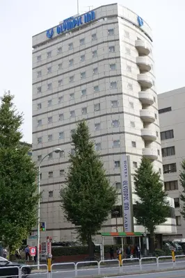 a building with a sign on the side of it at Olympic Inn Azabu in Tokyo