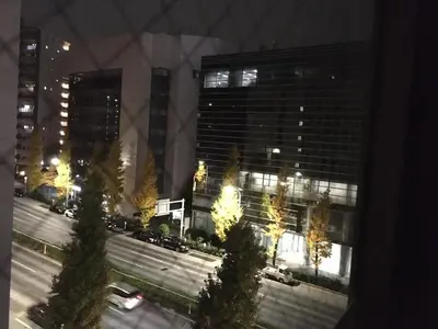 a view of a city street at night with buildings at Olympic Inn Azabu in Tokyo