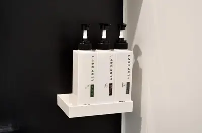 a white shelf with four electronic devices on a wall at HOTEL TAVINOS Hamamatsucho - Vacation STAY 51014 in Tokyo