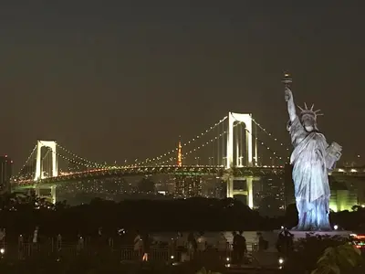 a view of the statue of liberty at night with a bridge at HOTEL TAVINOS Hamamatsucho - Vacation STAY 51014 in Tokyo