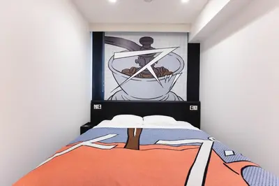 a bedroom with a bed and a painting on the wall at HOTEL TAVINOS Hamamatsucho - Vacation STAY 51014 in Tokyo