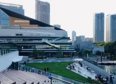 a large building with a green lawn in front of it at HOTEL TAVINOS Hamamatsucho - Vacation STAY 51015 in Tokyo