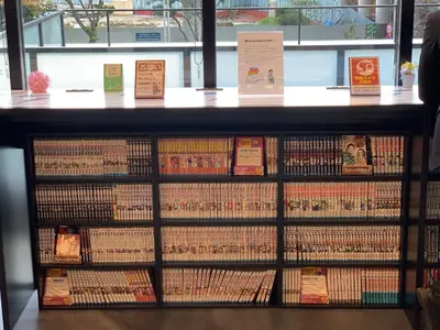 a book shelf filled with lots of books at HOTEL TAVINOS Hamamatsucho - Vacation STAY 51015 in Tokyo