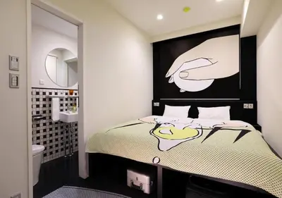 a bedroom with a bed with a hand painted on the wall at HOTEL TAVINOS Hamamatsucho - Vacation STAY 51015 in Tokyo