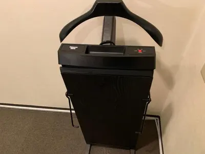 a black printer sitting on a stand next to a wall at Roppongi Plaza Hotel in Tokyo