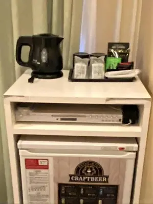 a microwave oven with a counter top on top of it at Roppongi Plaza Hotel in Tokyo
