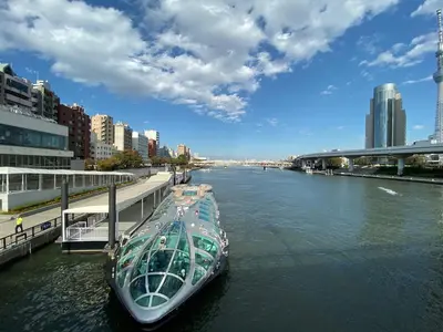 a boat is docked on a river in a city at HOTEL Japonica in Tokyo