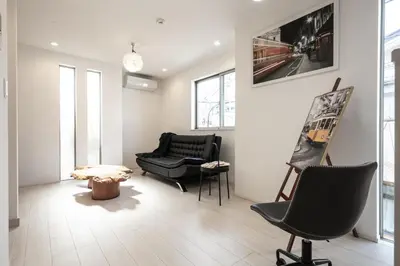 a living room with two chairs and a table at Private Hotel Oshiage in Tokyo
