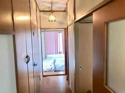 a room with a bedroom with a bed and a mirror at \u9326\u306e\u9928 Nishiki\u306eYakata in Tokyo