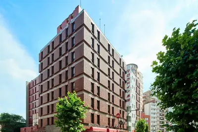 a tall brick building with a cross on top of it at Marroad Inn Akasaka in Tokyo