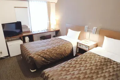 a hotel room with two beds and a television at Marroad Inn Akasaka in Tokyo