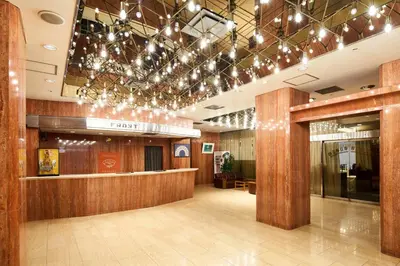 a lobby with a bar with lights on the ceiling at Marroad Inn Akasaka in Tokyo