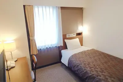 a hotel room with a bed and a window at Marroad Inn Akasaka in Tokyo