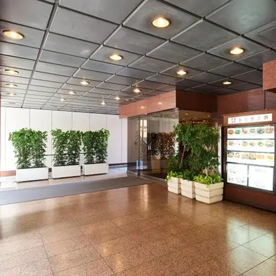 a lobby with plants in pots in a building at Marroad Inn Akasaka in Tokyo