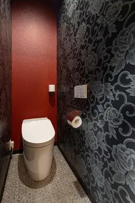 a bathroom with a toilet and a wall at ESTABLISHMENT Asakusa in Tokyo