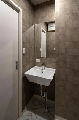a bathroom with a sink and a mirror at ESTABLISHMENT Asakusa in Tokyo