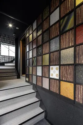 a wall of stained glass windows in a lobby at ESTABLISHMENT Asakusa in Tokyo