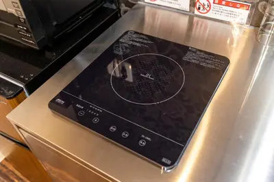 a tablet computer sitting on top of a stove at ESTABLISHMENT Asakusa in Tokyo