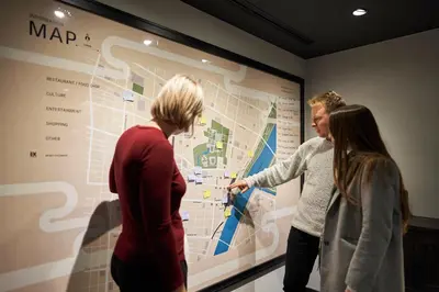 a group of people looking at a map on a wall at Resol Poshtel Tokyo Asakusa in Tokyo