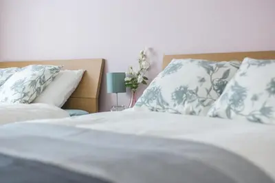 a bedroom with two beds with pillows and a lamp at SHINJUKU Residence BLDG in Tokyo