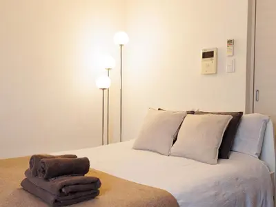 a bedroom with a bed with two towels on it at SHINJUKU Residence BLDG in Tokyo