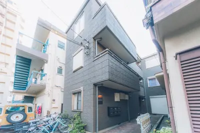 a brick building with bikes parked outside of it at nestay suite tokyo shibuya in Tokyo