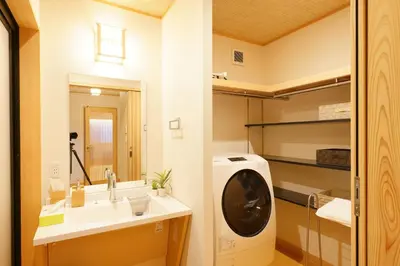 a bathroom with a sink and a washing machine at YADOYA Uguisu in Tokyo
