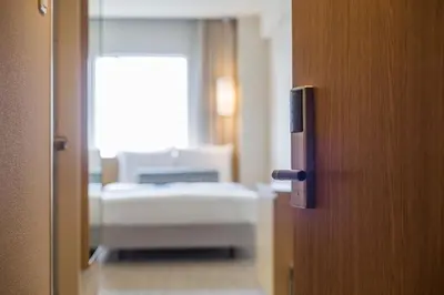a door to a bedroom with a bed in a room at Hotel Mystays Premier Hamamatsucho in Tokyo