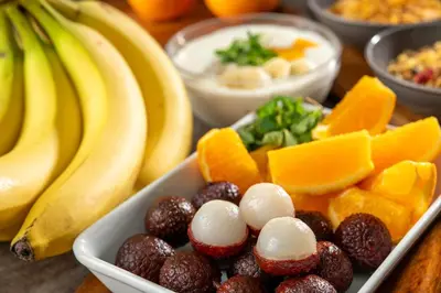 a table topped with bowls of fruit and bananas at Hotel Mystays Premier Hamamatsucho in Tokyo