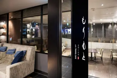 a room with a couch and a dining room at Hotel Mystays Premier Hamamatsucho in Tokyo