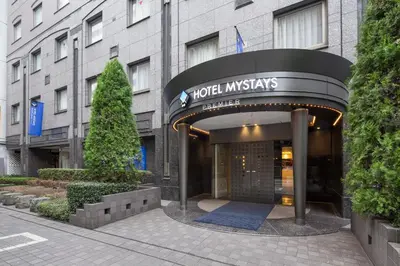 a hotel entrance with a sign for the hotel insignias at Hotel Mystays Premier Hamamatsucho in Tokyo