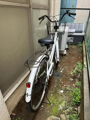a white bike parked next to a building at Vivian house in Tokyo