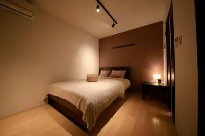 a small bedroom with a bed and a night stand at CORDEA\u516b\u5e83 in Tokyo