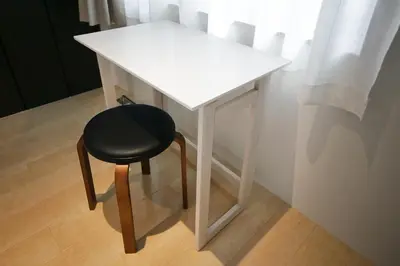a white table with a black chair next to a window at CORDEA\u516b\u5e83 in Tokyo