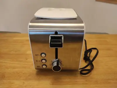 a toaster sitting on top of a wooden table at OMM STAY in Tokyo
