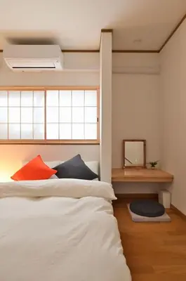 a bedroom with a bed with two pillows on it at OMM STAY in Tokyo