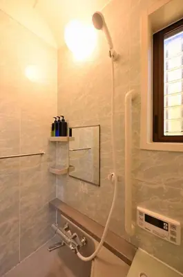 a bathroom with a shower with a shower head at OMM STAY in Tokyo