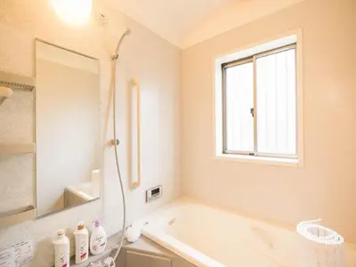 a white bathroom with a tub and a window at Katsushika Takasago House in Tokyo