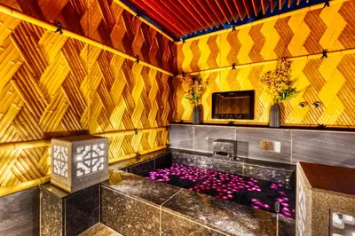 a room with a tub with purple flowers and a tv at HOTEL Lotus Shibuya (Adult Only) in Tokyo