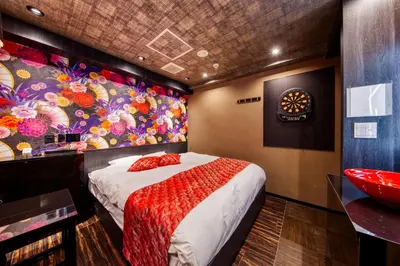a bedroom with a bed and a colorful wall at HOTEL Lotus Ikebukuro (Adult Only) in Tokyo