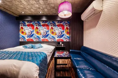 a small room with a bed and a couch at HOTEL Lotus Ikebukuro (Adult Only) in Tokyo